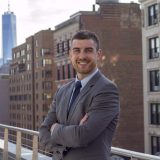 Man smiling, wearing a suit