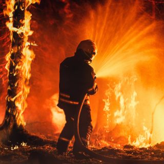 Firefighter battles wildfire.