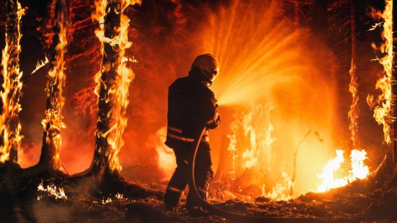 Firefighter battles wildfire.