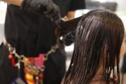 Woman having hair straightened