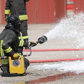 Firefighrer spraying AFFF foam