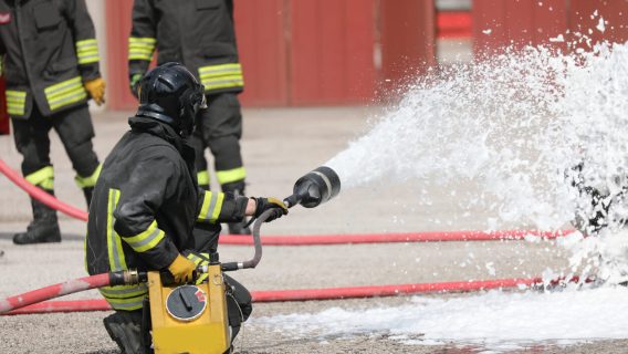 Firefighrer spraying AFFF foam