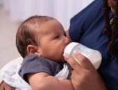 Baby being fed from a bottle