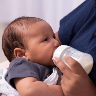 Baby being fed from a bottle