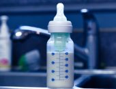 Baby bottle with formula on kitchen sink